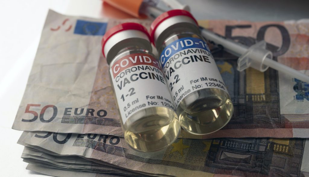 Covid-19 coronavirus vaccine for vaccination plan together with banknotes