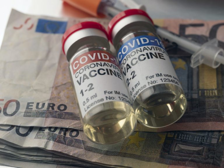 Covid-19 coronavirus vaccine for vaccination plan together with banknotes